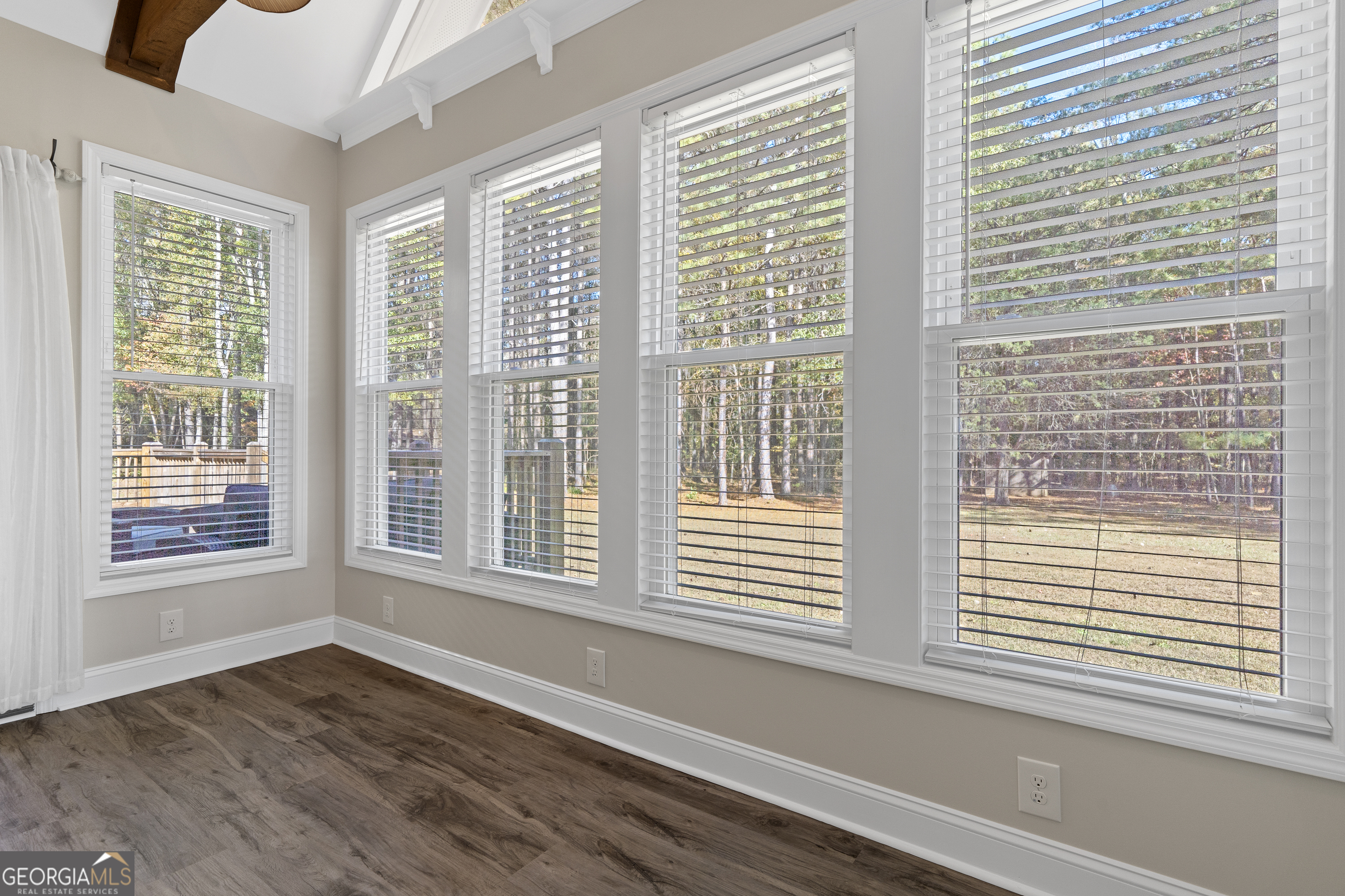 1050 Sugar Creek Church Road Madison, GA 30650 - Photo 21 of 60 a view of an empty room with wooden floor and a window
