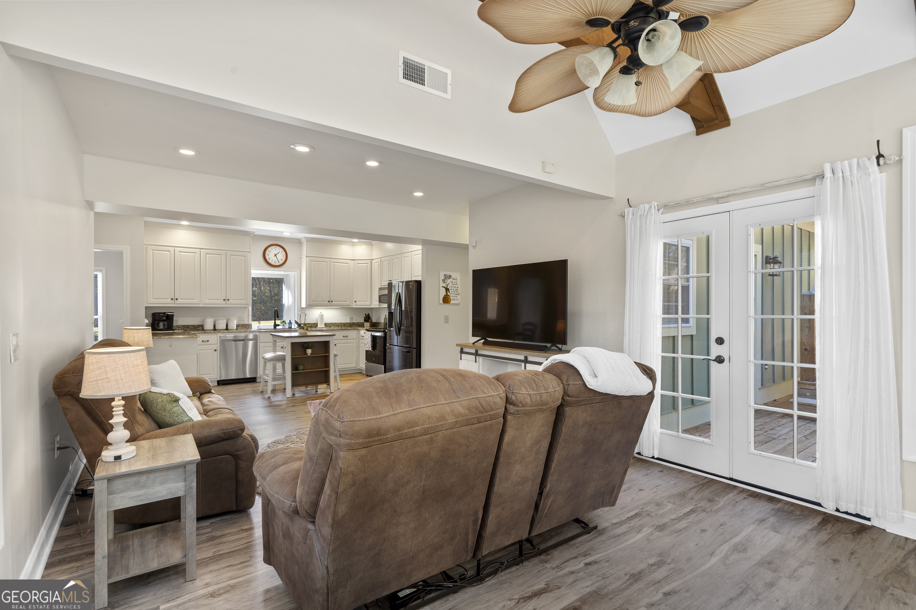 1050 Sugar Creek Church Road Madison, GA 30650 - Photo 22 of 60 a living room with furniture and a flat screen tv