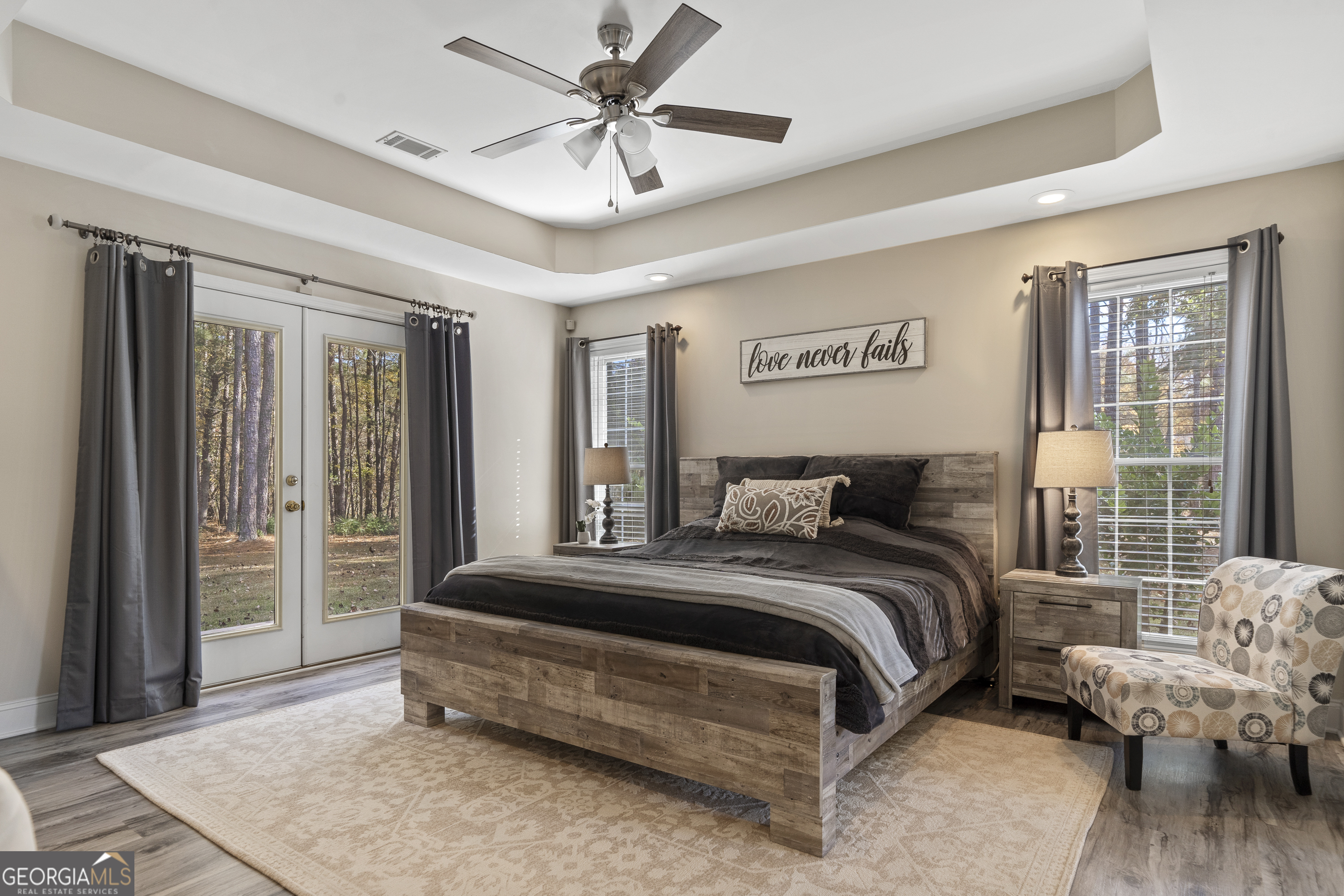 1050 Sugar Creek Church Road Madison, GA 30650 - Photo 23 of 60 a spacious bedroom with a bed and glass door