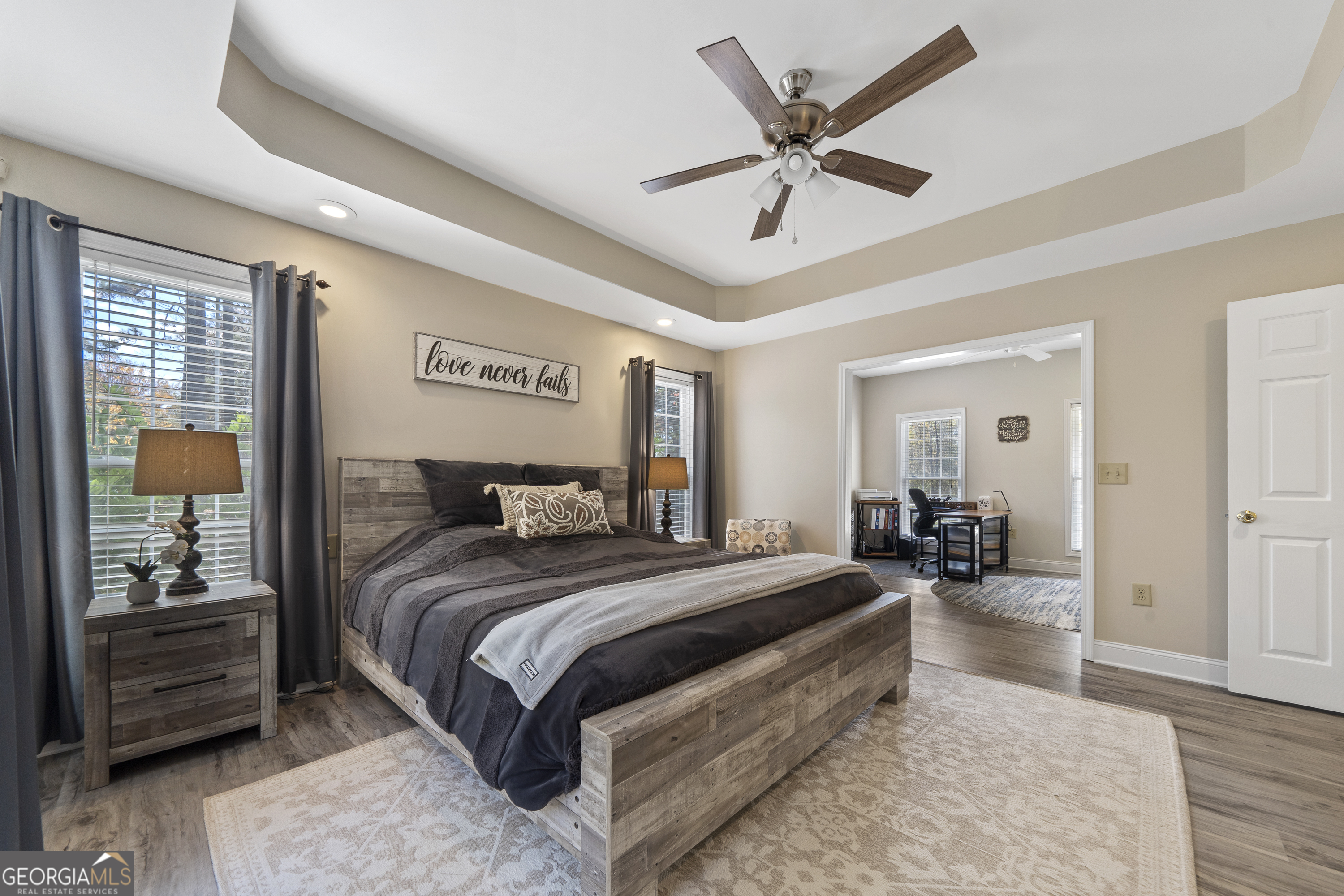 1050 Sugar Creek Church Road Madison, GA 30650 - Photo 24 of 60 a bedroom with a large bed and ceiling fan