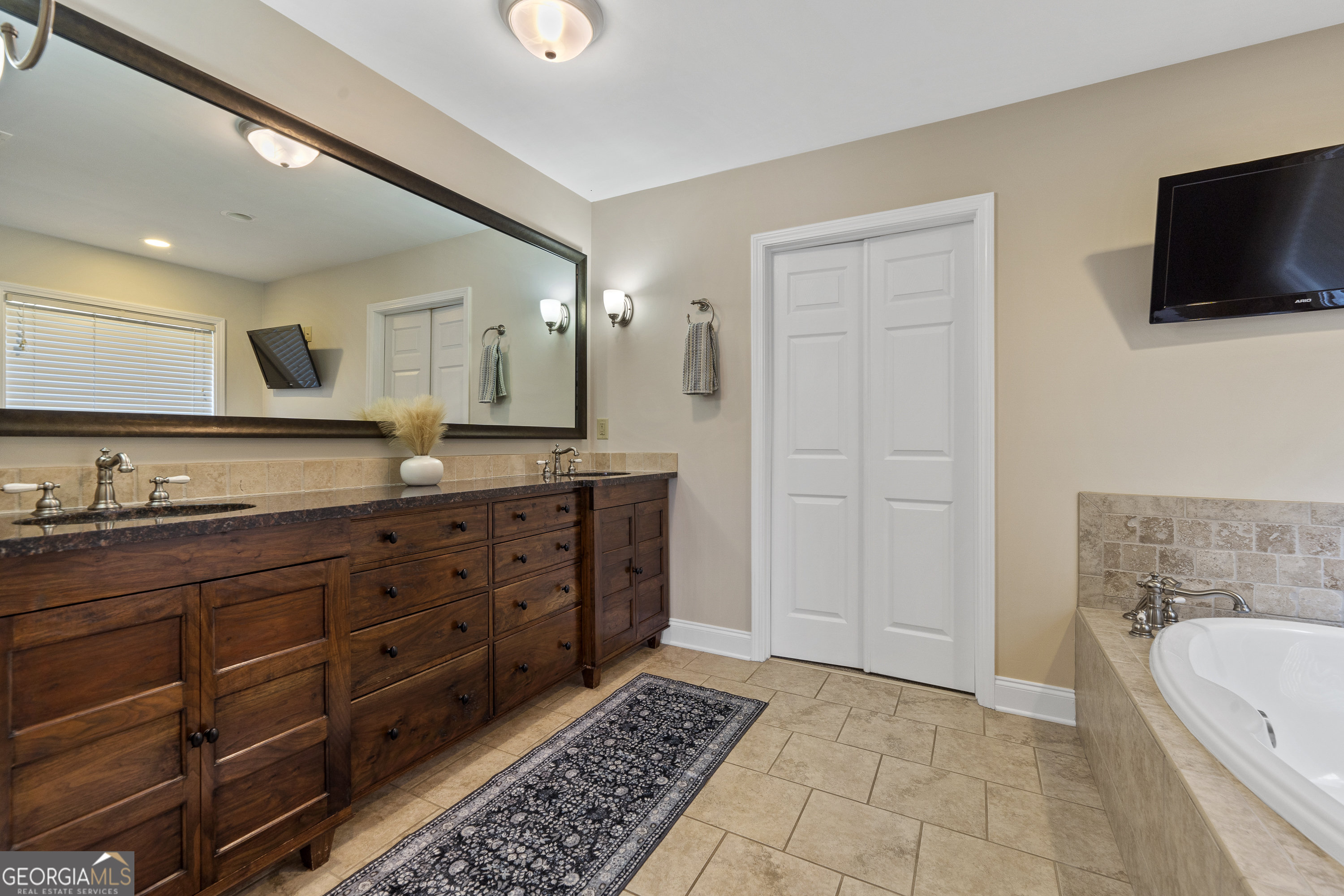 1050 Sugar Creek Church Road Madison, GA 30650 - Photo 25 of 60 a spacious bathroom with a granite countertop sink mirror and bathtub