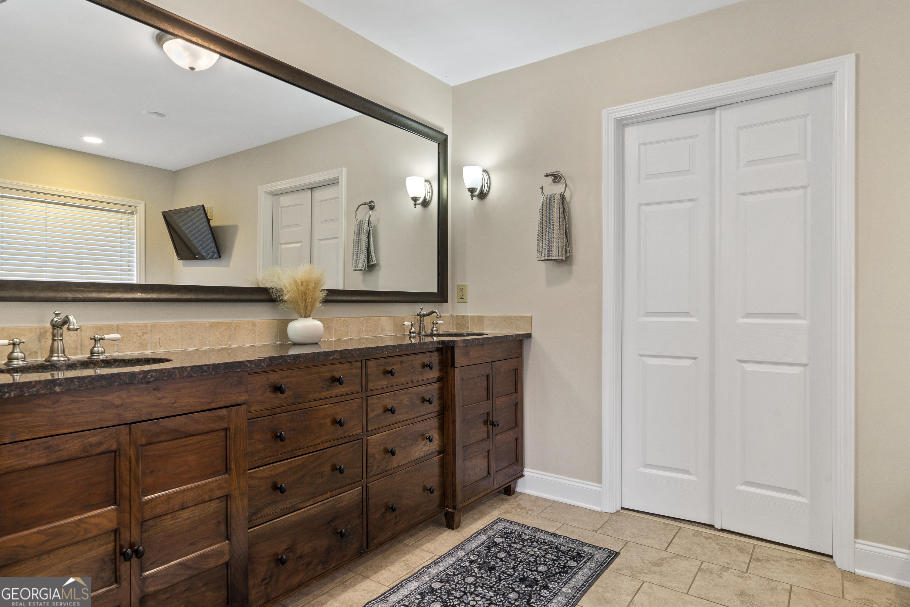1050 Sugar Creek Church Road Madison, GA 30650 - Photo 26 of 60 a bathroom with a granite countertop double vanity sink mirror and