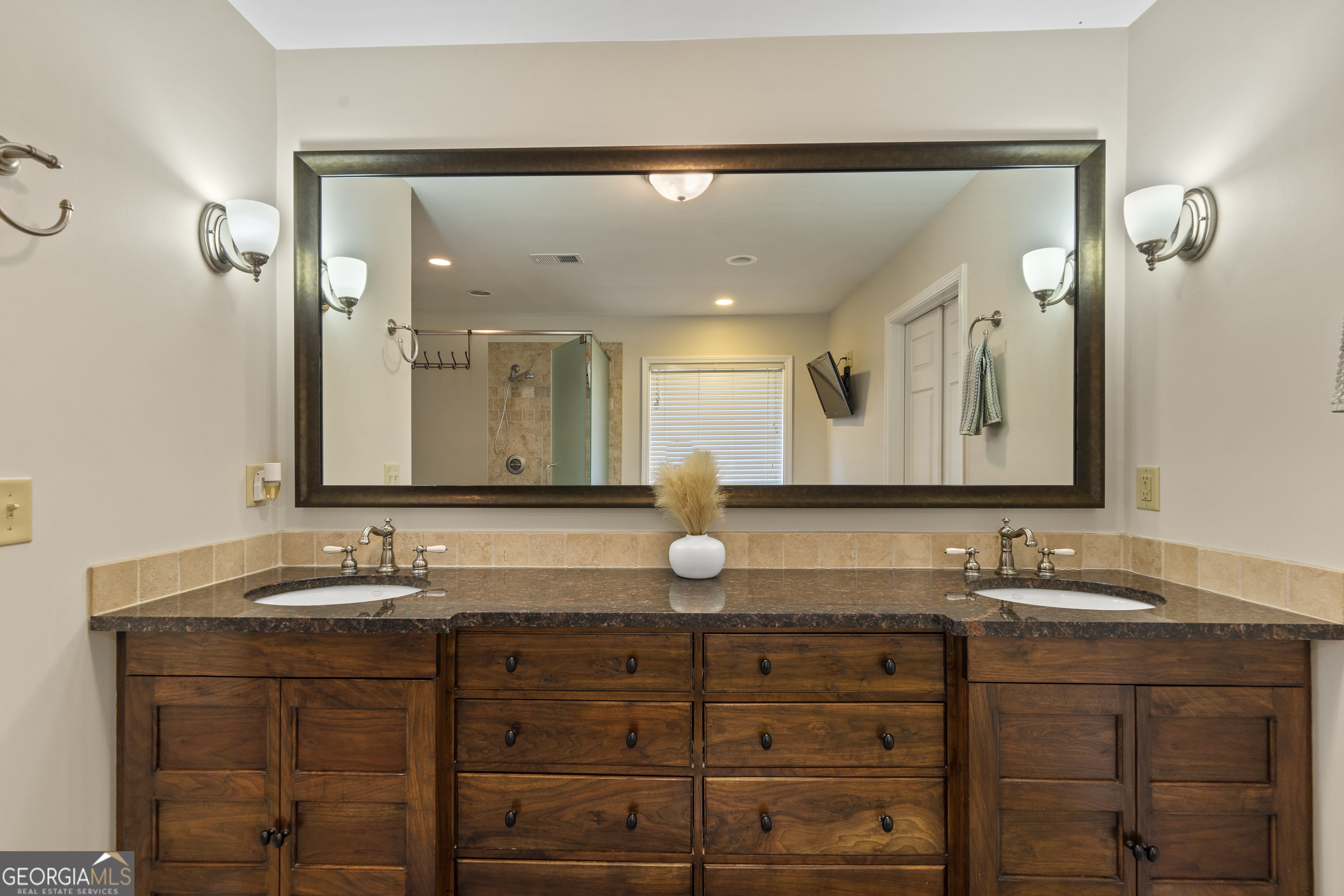 1050 Sugar Creek Church Road Madison, GA 30650 - Photo 27 of 60 a bathroom with double vanity and a mirror