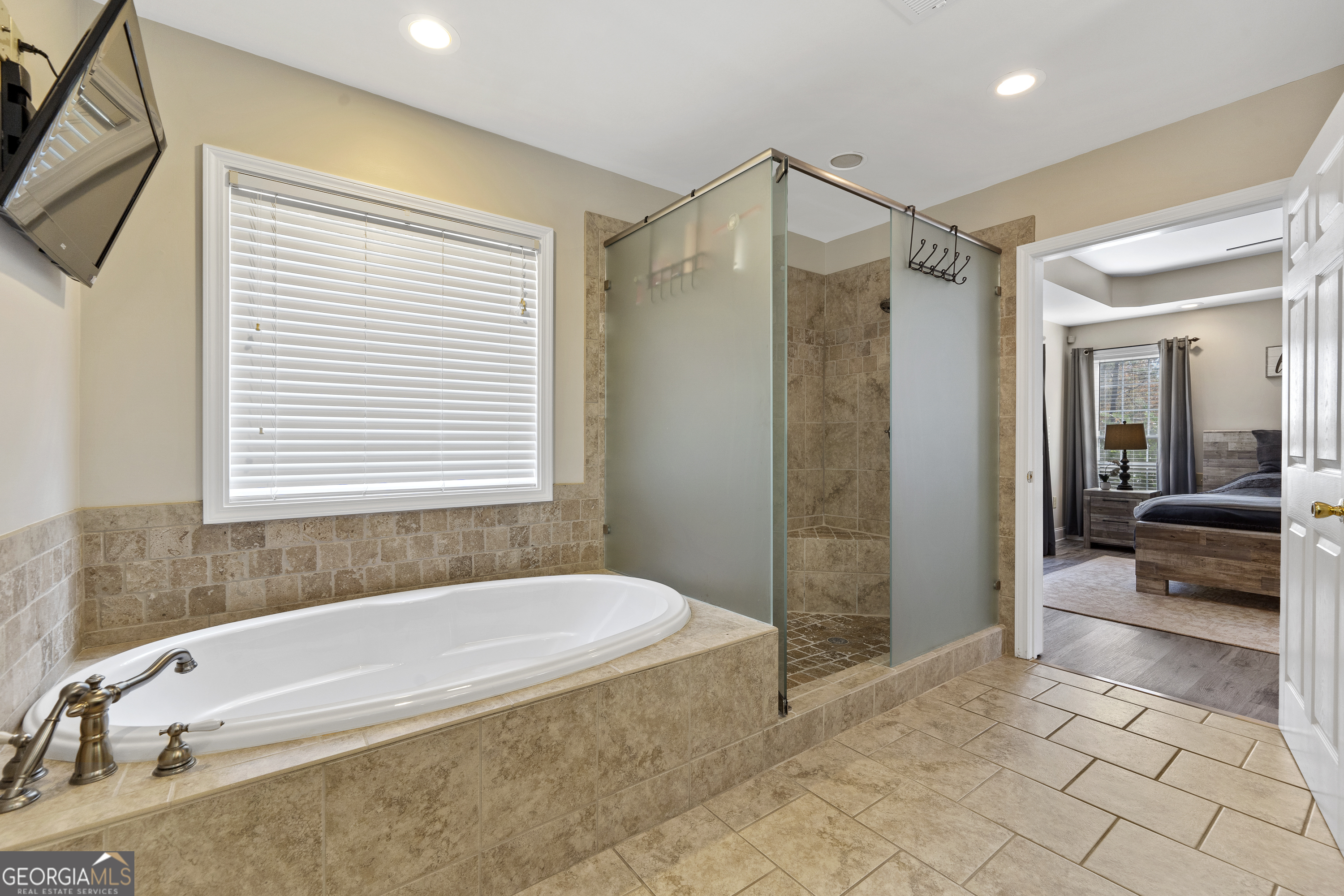 1050 Sugar Creek Church Road Madison, GA 30650 - Photo 28 of 60 a spacious bathroom with a granite countertop tub shower and sink