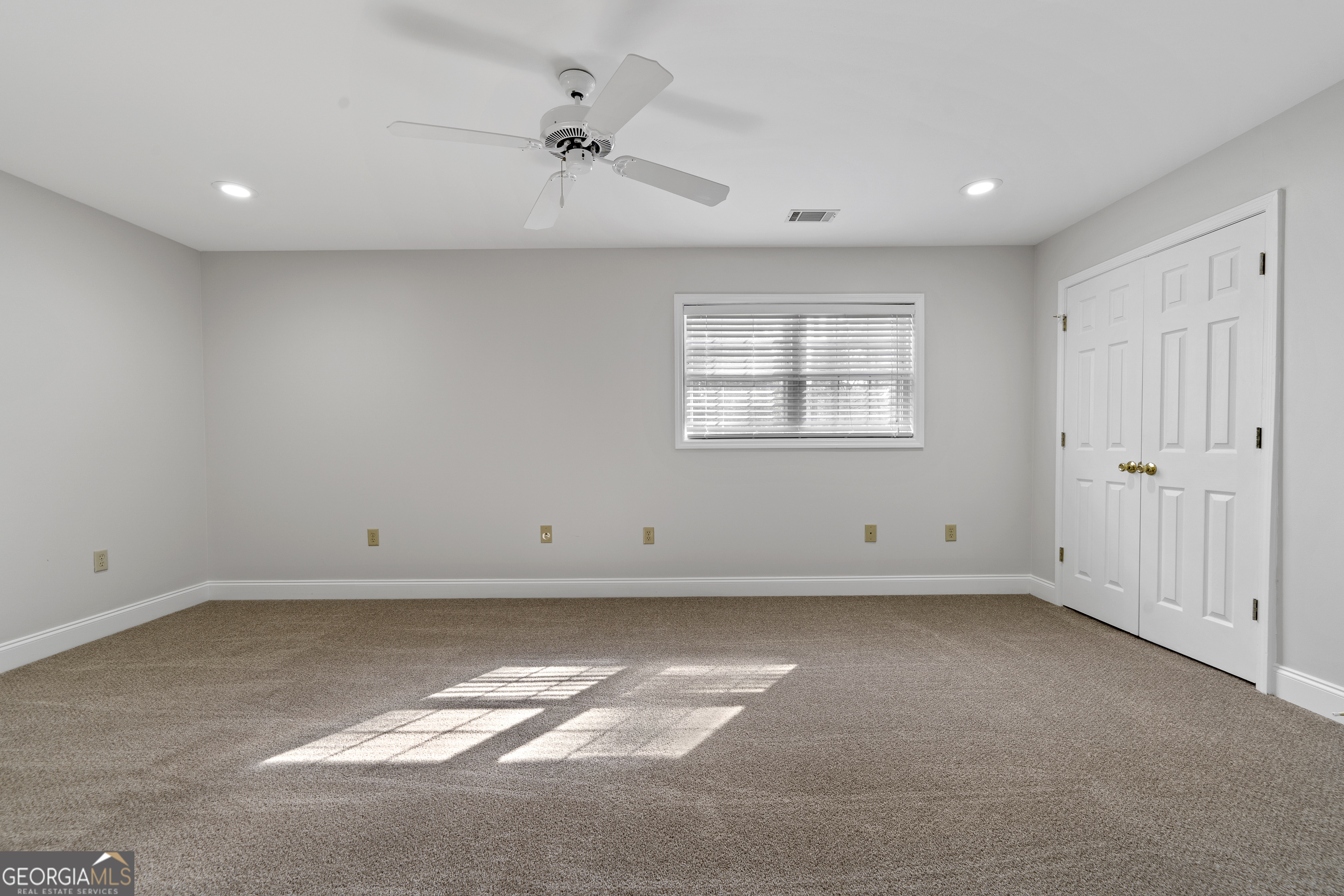 1050 Sugar Creek Church Road Madison, GA 30650 - Photo 35 of 60 an empty room with a window and a fan