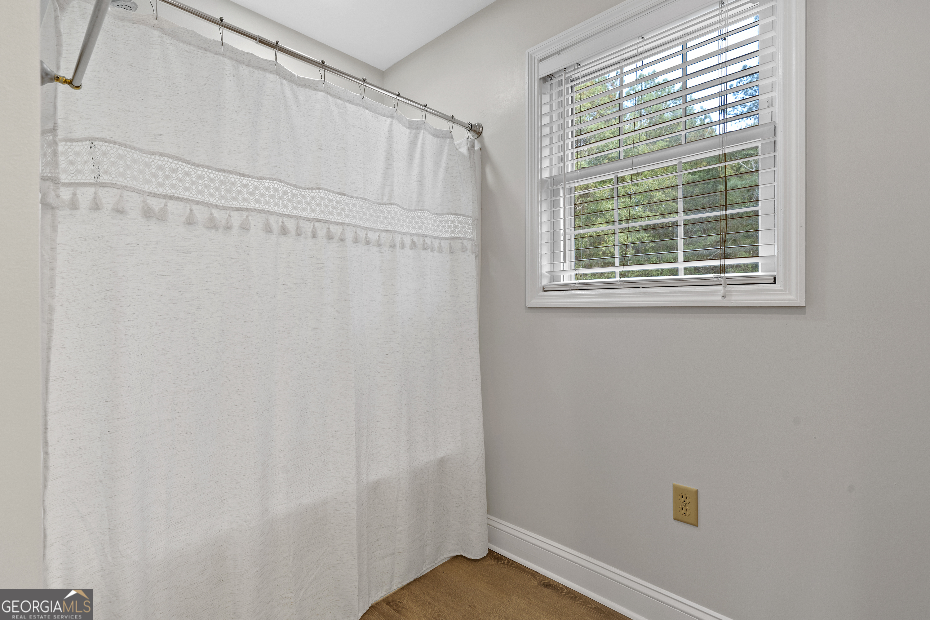 1050 Sugar Creek Church Road Madison, GA 30650 - Photo 40 of 60 a view of a small space with a window and a shower curtain