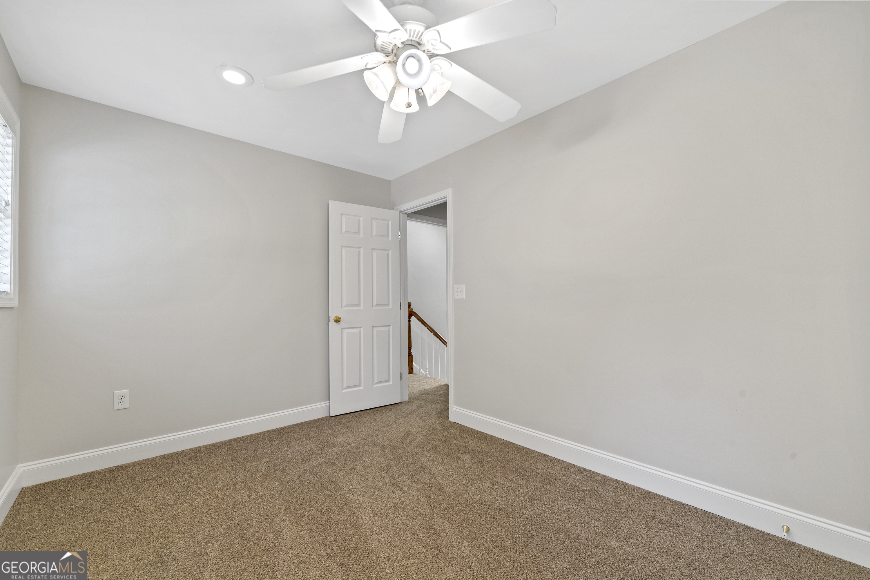 1050 Sugar Creek Church Road Madison, GA 30650 - Photo 44 of 60 an empty room with a chandelier fan and closet area