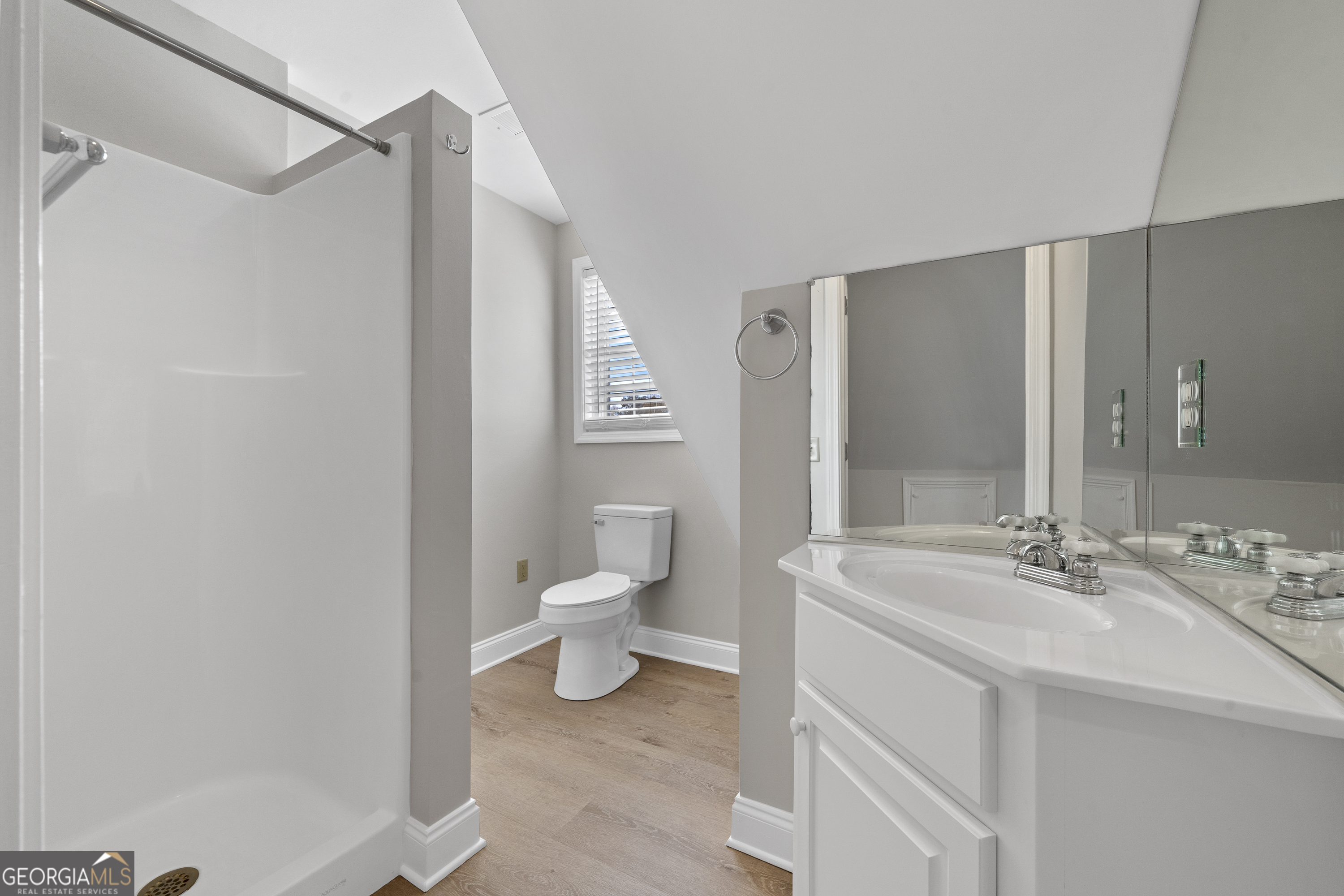 1050 Sugar Creek Church Road Madison, GA 30650 - Photo 50 of 60 a bathroom with a sink mirror and a toilet