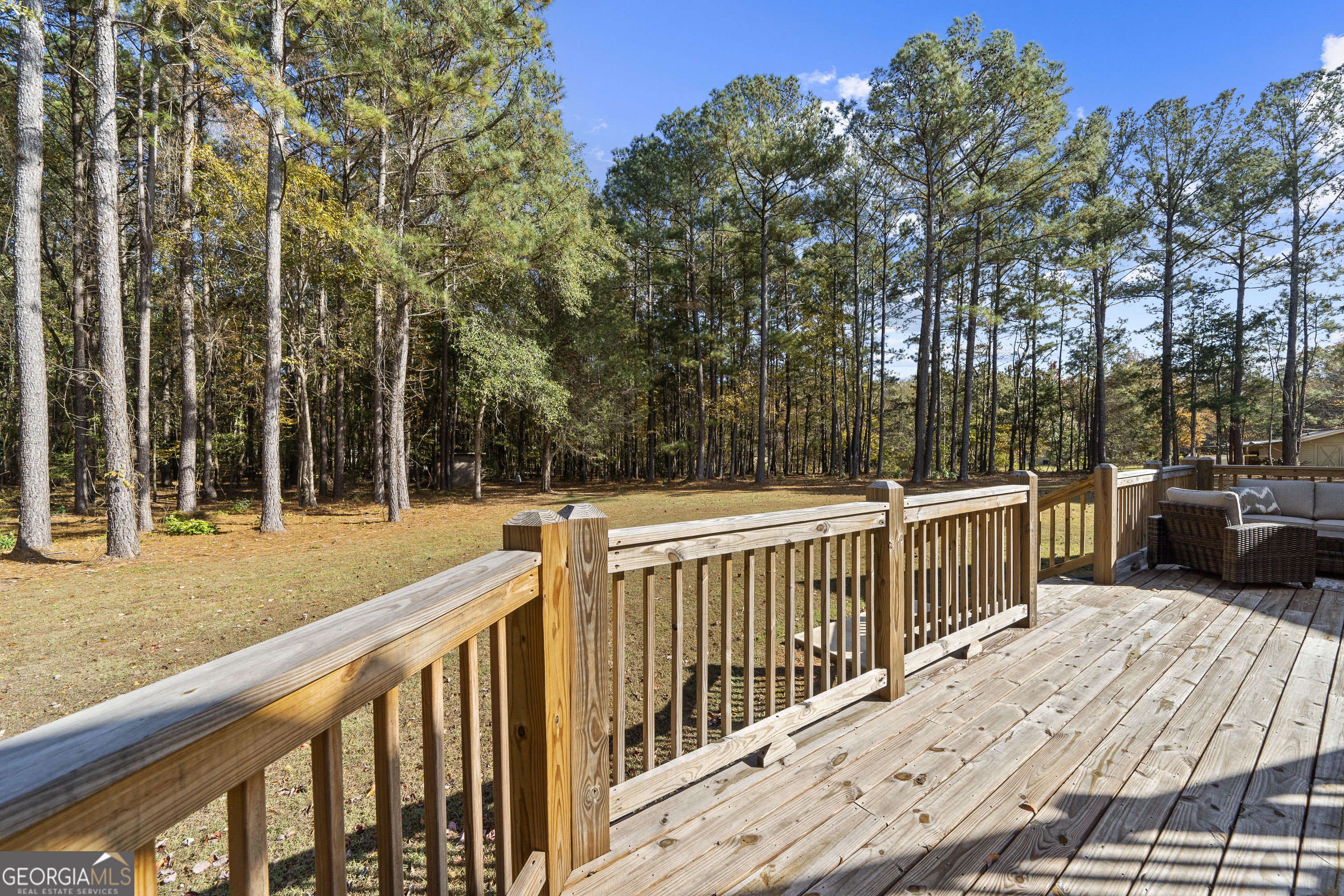 1050 Sugar Creek Church Road Madison, GA 30650 - Photo 55 of 60 a view of a wooden balcony and trees