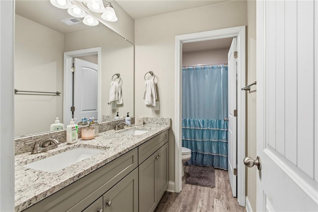 171 Strickland Loop Forsyth, GA 31029 - Photo 16 of 25 a bathroom with a granite countertop sink double vanity and mirror