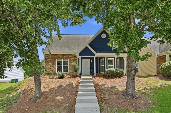 a front view of a house with a garden