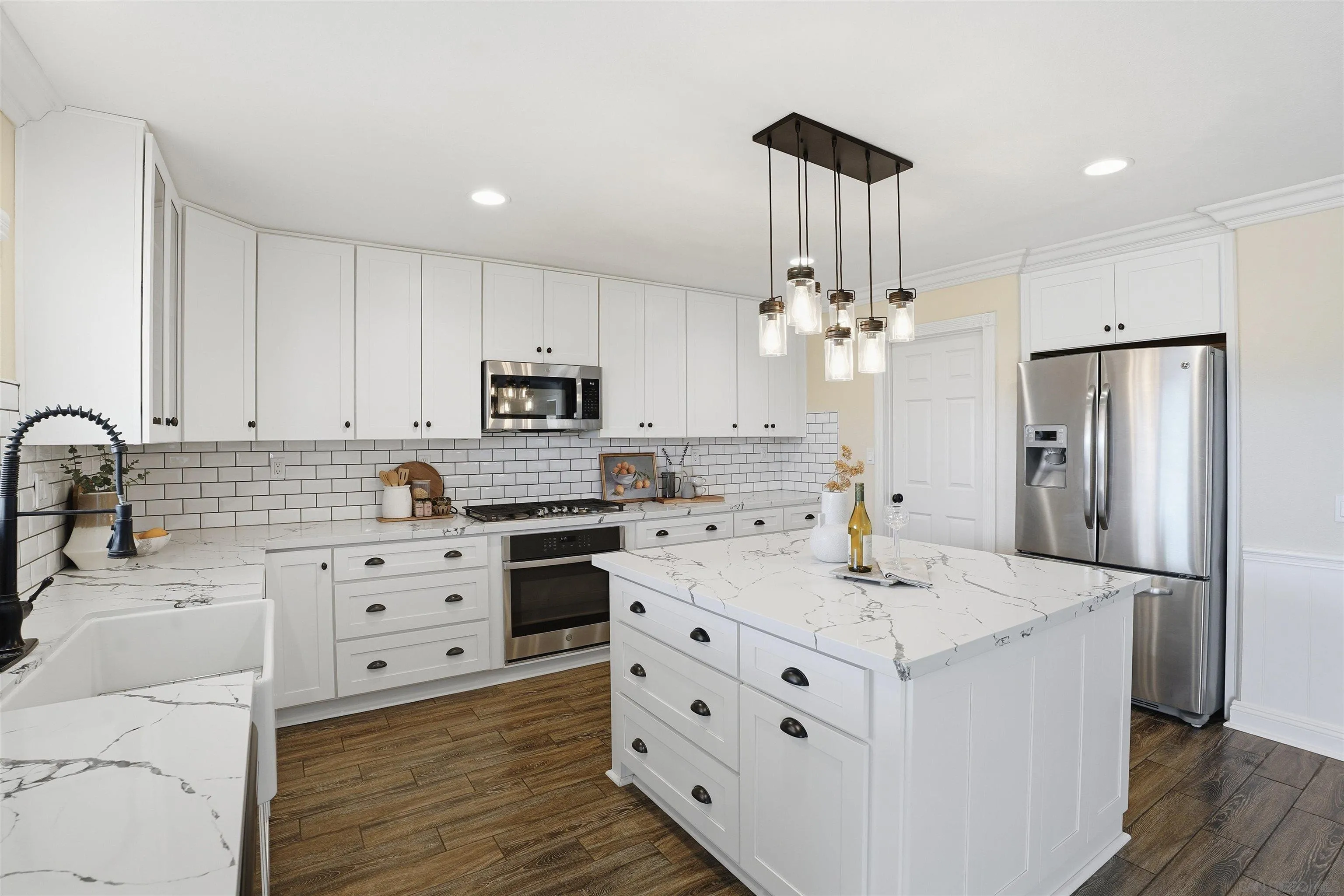 32892 Monte Drive Temecula, CA 92592 - Photo 19 of 60 a kitchen with kitchen island a sink stainless steel appliances and cabinets