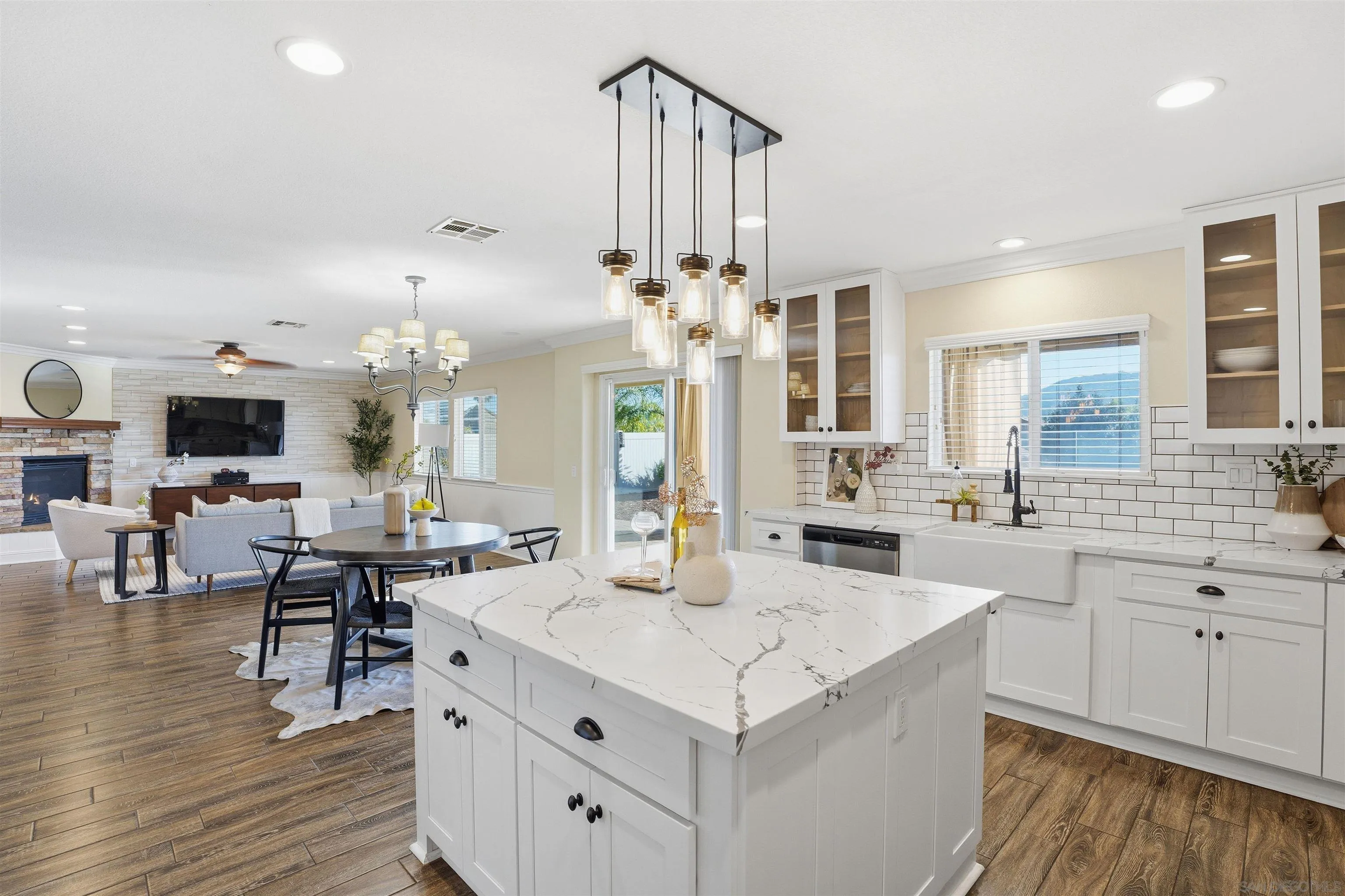32892 Monte Drive Temecula, CA 92592 - Photo 24 of 60 a large kitchen with a counter space a sink appliances and living room view