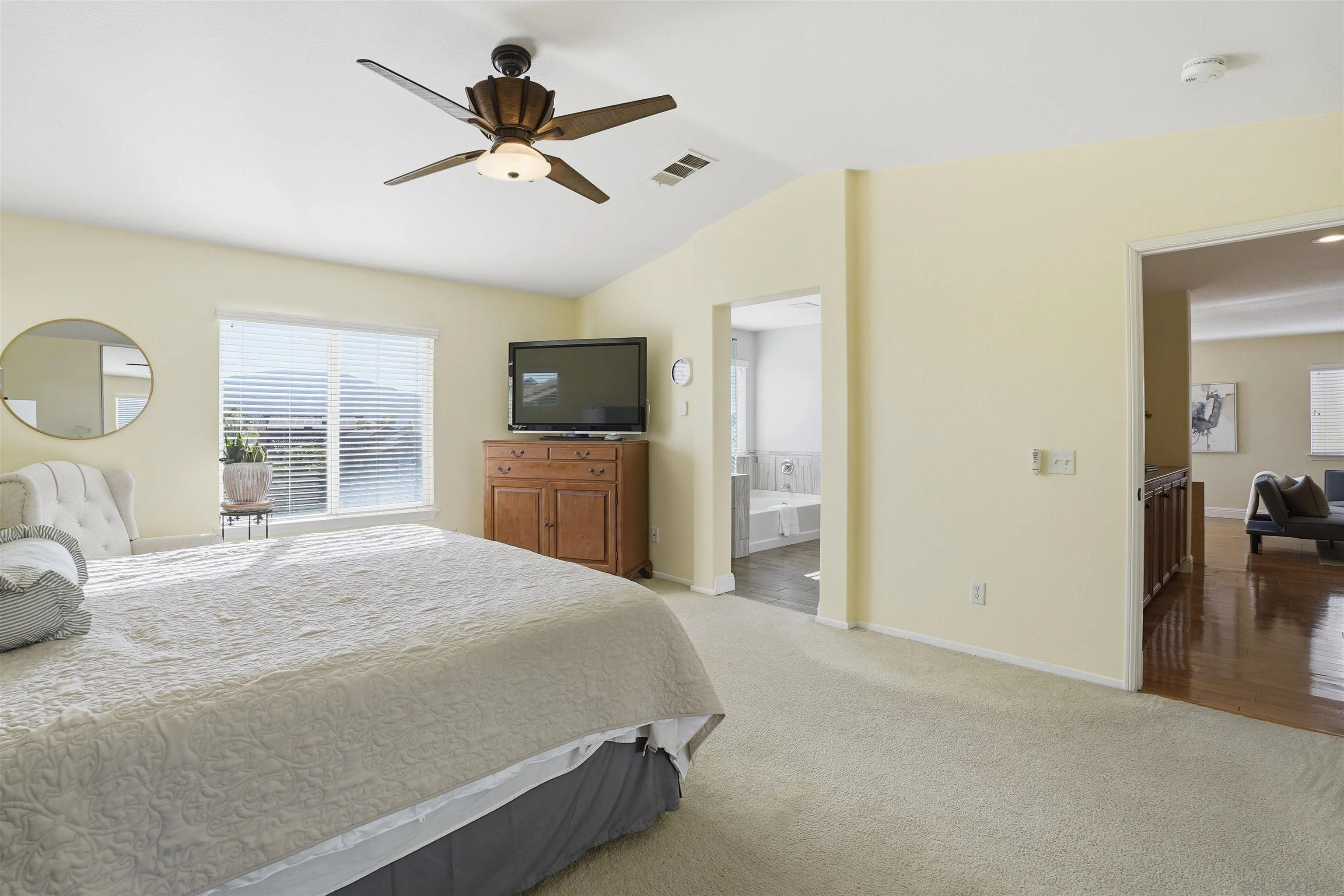 32892 Monte Drive Temecula, CA 92592 - Photo 33 of 60 a spacious bedroom with a bed and a flat screen tv