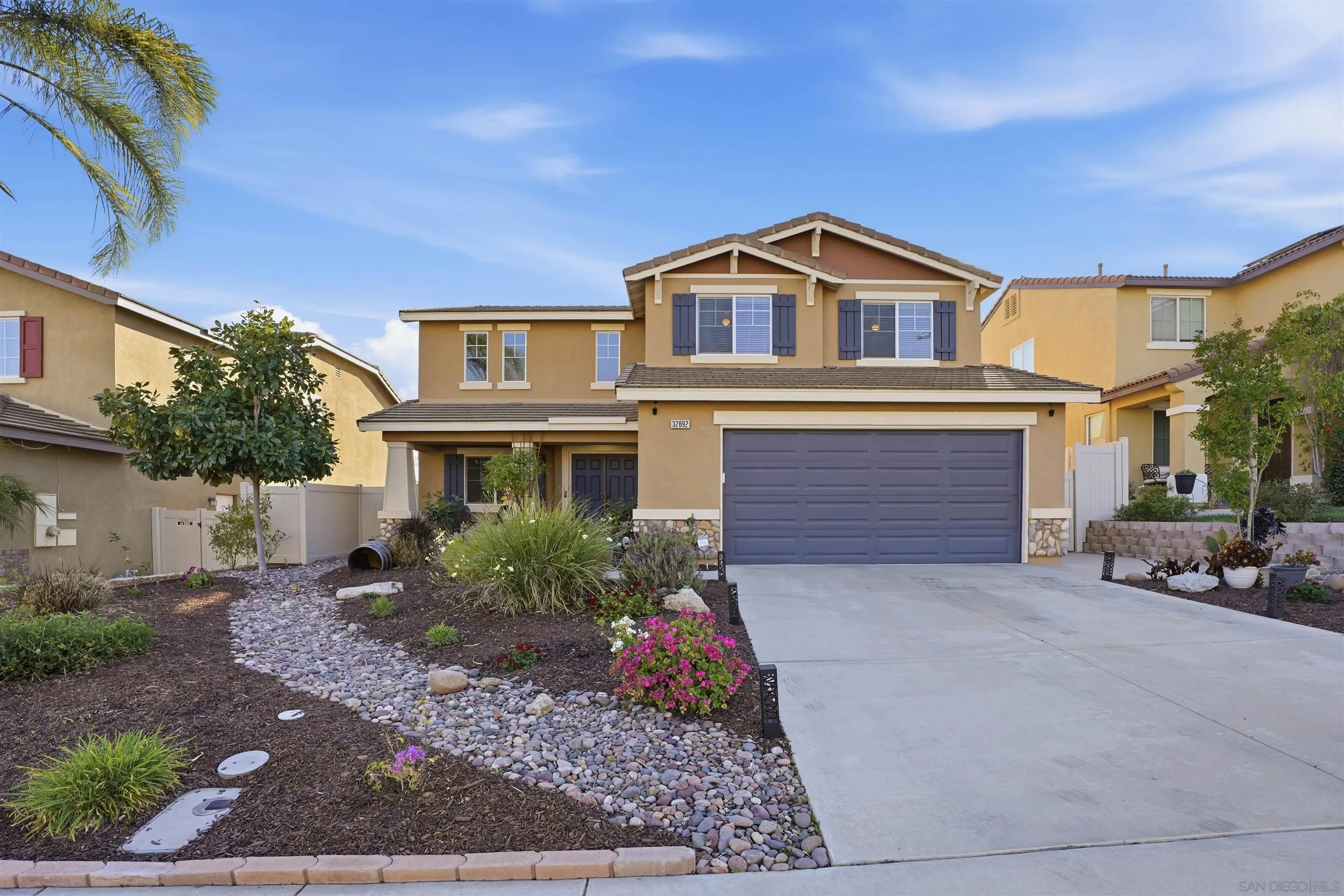 32892 Monte Drive Temecula, CA 92592 - Photo 43 of 60 a front view of a house with a yard and garage
