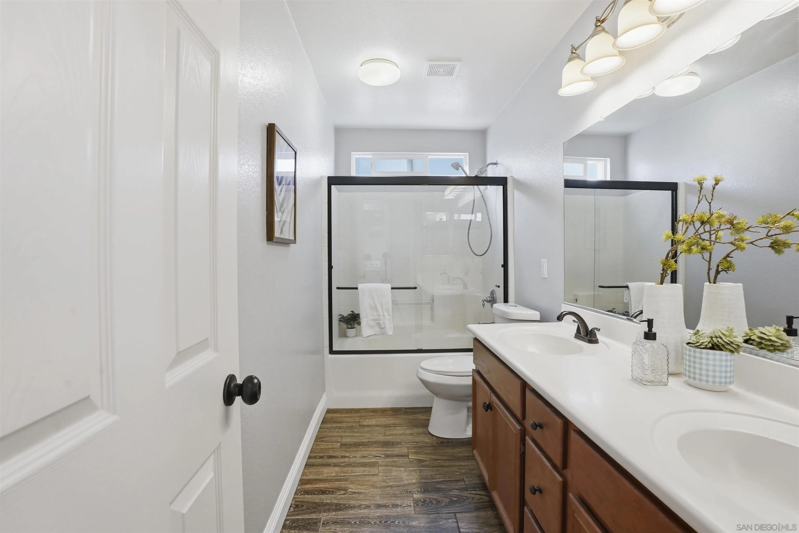 32892 Monte Drive Temecula, CA 92592 - Photo 57 of 60 a bathroom with a double vanity sink toilet and shower