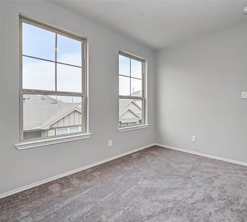 a view of a hallway with wooden floor and stairs
