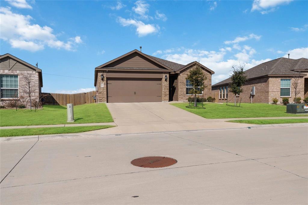 1012 Calhoun Drive Anna, TX 75409 - Photo 3 of 39 Single-story brick exterior with an attached two-car garage