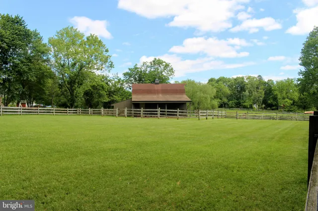 a view of a room that has wooden floor and a bed