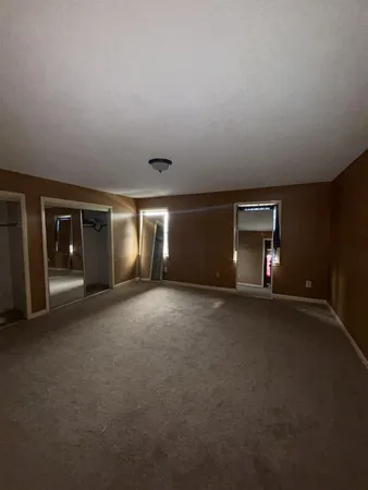 a view of empty room with window and fireplace