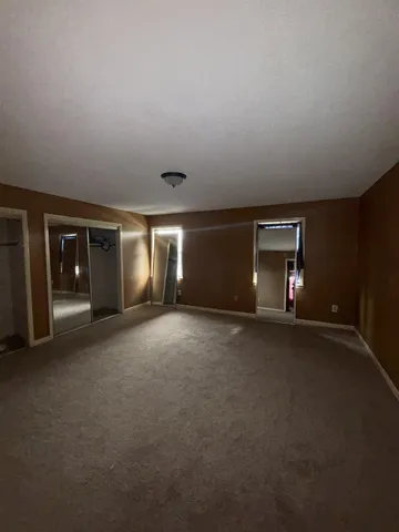 a view of empty room with window and fireplace