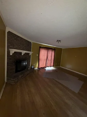 a view of empty room with window and fireplace