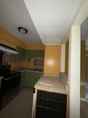 a kitchen with a stove and a refrigerator