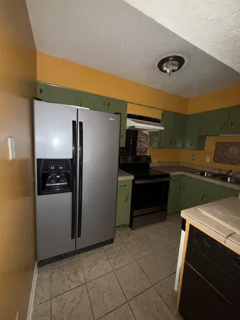 a kitchen with a refrigerator and a sink