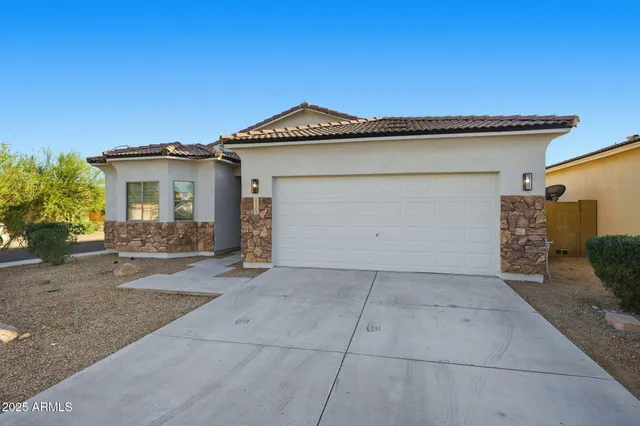 a view of a house with a yard and garage