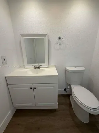 a bathroom with a toilet a sink and mirror