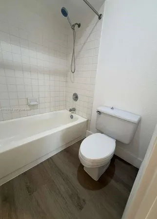 a bathroom with a toilet and a bathtub