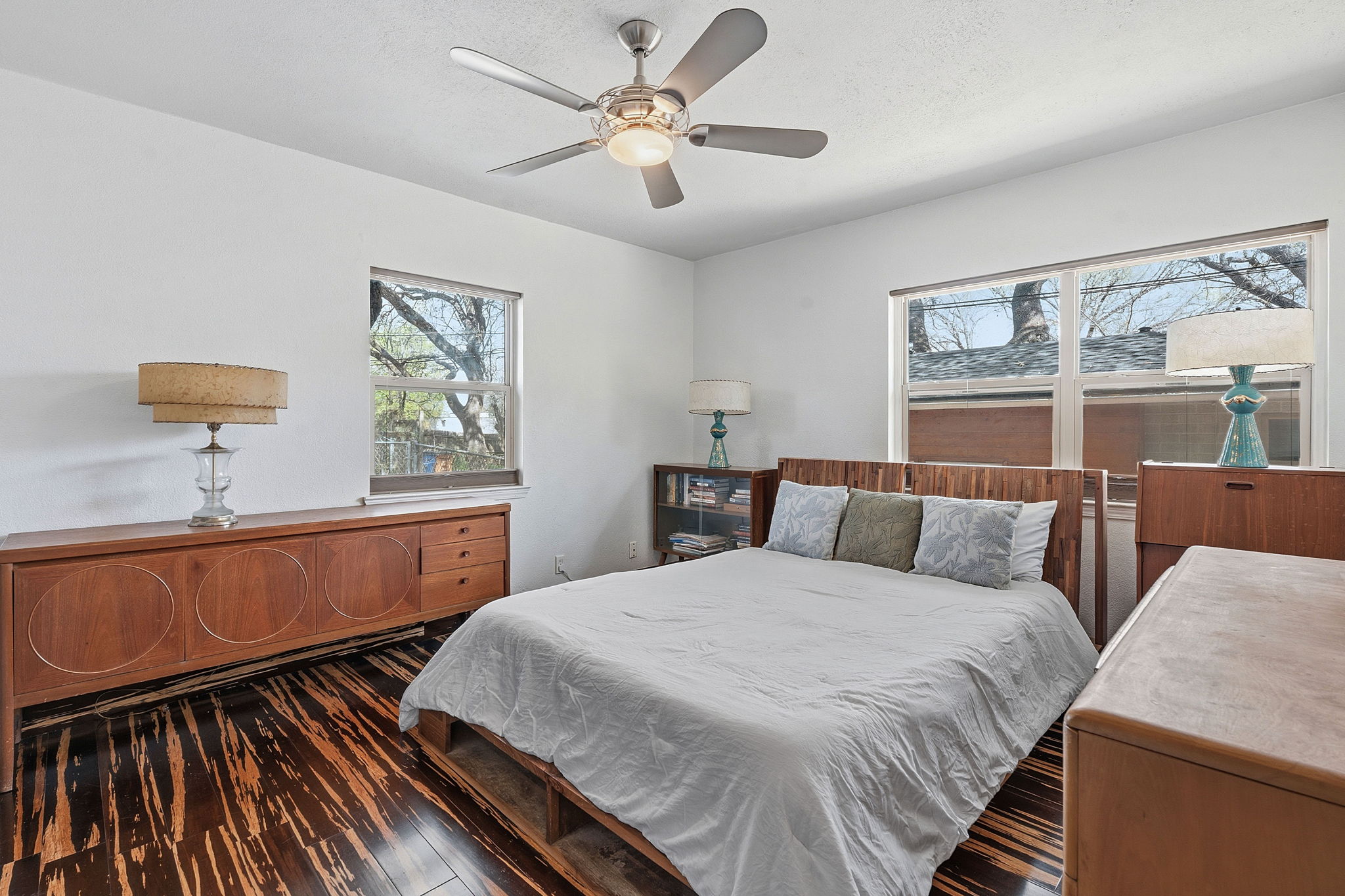 1112 Mission Ridge Austin, TX 78704 - Photo 11 of 22 a bedroom with a large bed and a chandelier