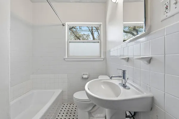 a bathroom with a sink a toilet and a bathtub