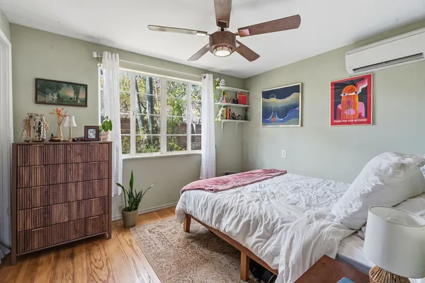 a bedroom with a bed and a window