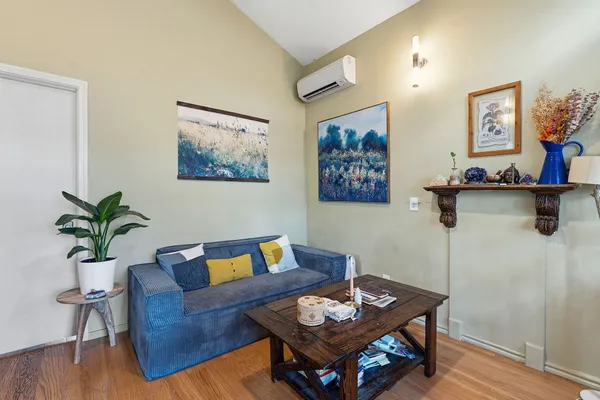 a living room with furniture and wooden floor