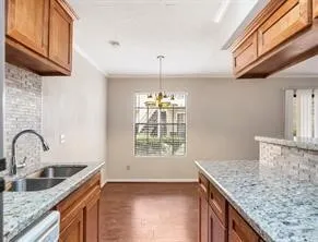 a kitchen with granite countertop a sink and a window