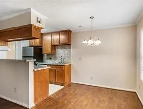 a kitchen with stainless steel appliances granite countertop a sink refrigerator and microwave