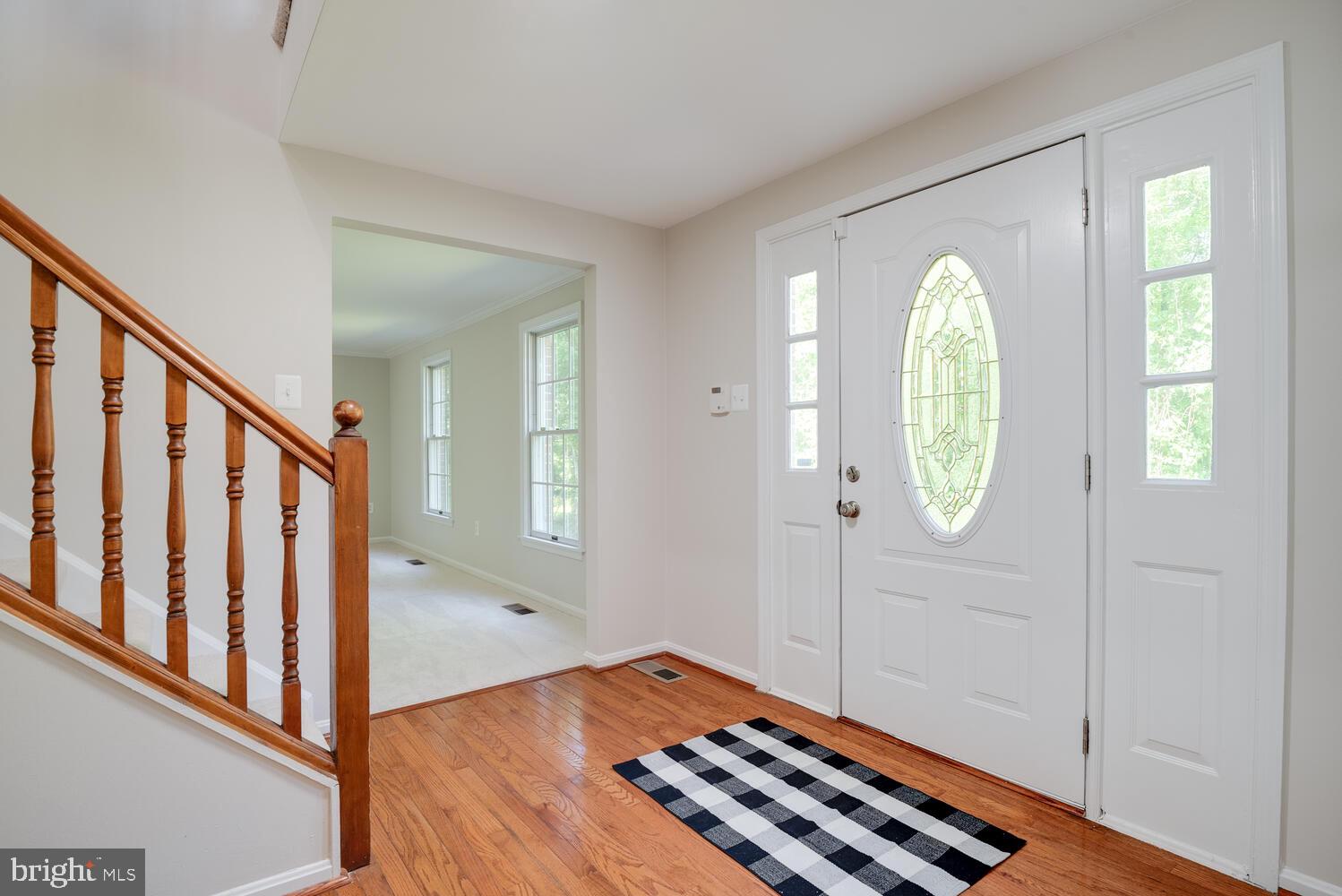 8115 Stacey Road Alexandria, VA 22308 - Photo 2 of 35 a view of a hallway with entryway and wooden floor