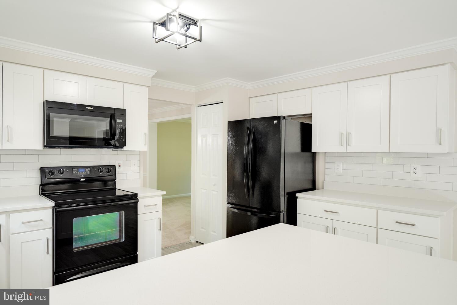 8115 Stacey Road Alexandria, VA 22308 - Photo 11 of 35 a kitchen with a refrigerator stove and microwave