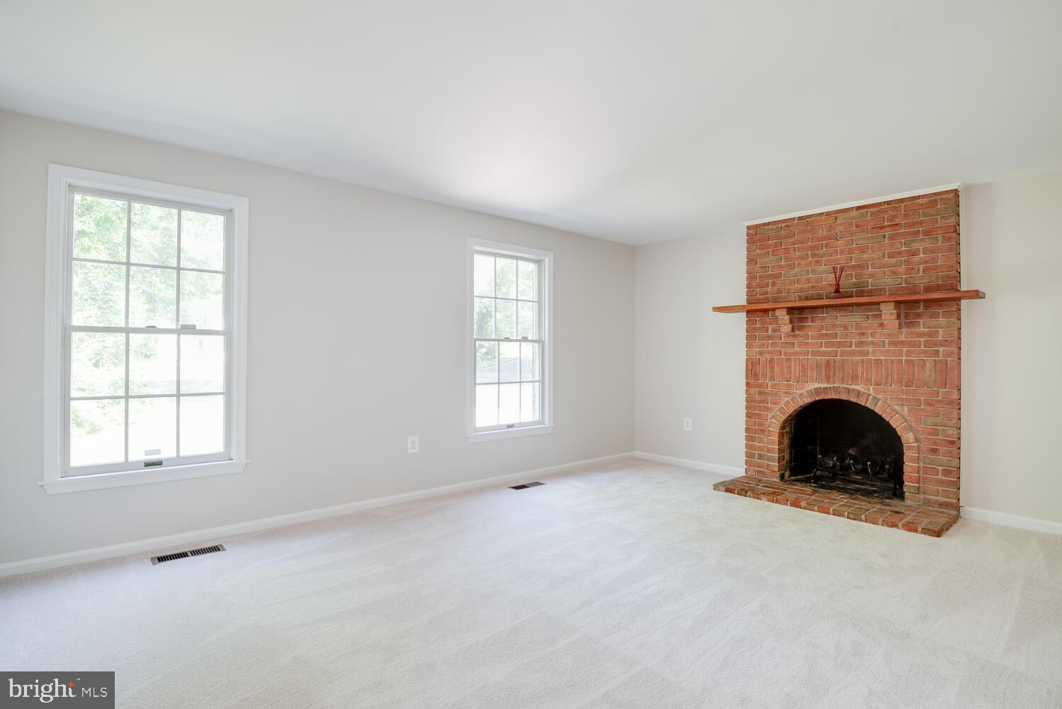 8115 Stacey Road Alexandria, VA 22308 - Photo 14 of 35 an empty room with windows and fireplace