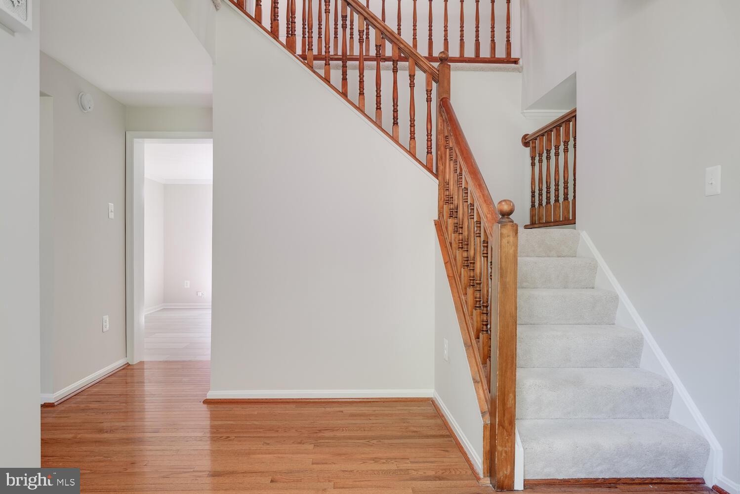 8115 Stacey Road Alexandria, VA 22308 - Photo 3 of 35 a view of staircase with wooden floor and white walls