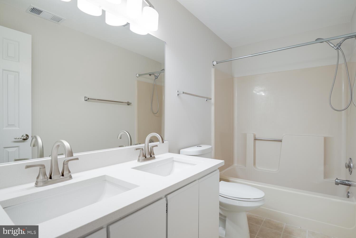 8115 Stacey Road Alexandria, VA 22308 - Photo 23 of 35 a bathroom with a sink a toilet and shower