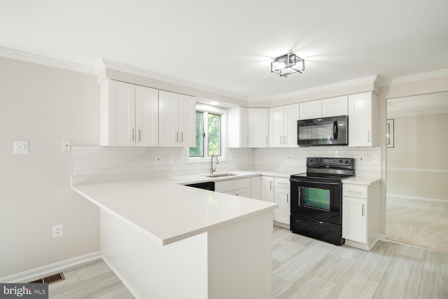 8115 Stacey Road Alexandria, VA 22308 - Photo 10 of 35 a kitchen with a stove a sink and a microwave