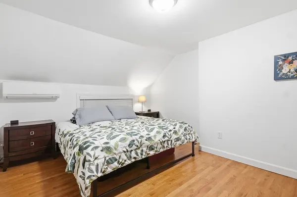 a bedroom with a bed and a night stand