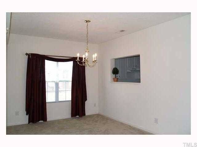 3360 Bridgeville Road Raleigh, NC 27610 - Photo 3 of 7 9' ceiling, neutral carpet, neutral wall paint, chandelier, double window with mini blinds Dining Room