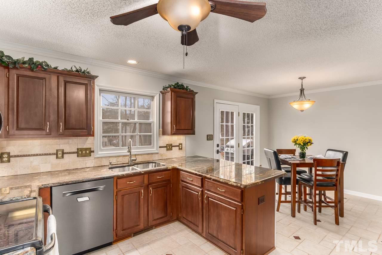 3429 Red Bay Drive Raleigh, NC 27616 - Photo 11 of 30 Featuring SS appliances, cherry cabs, granite tops, tile flooring and built-in desk or work space!