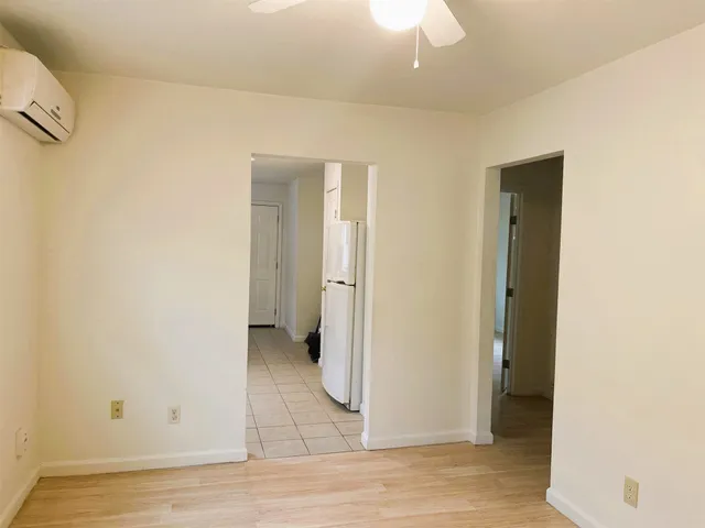 an empty room with wooden floor and closet