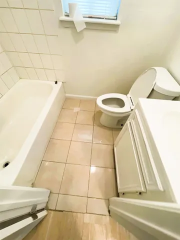 a bathroom with a bathtub and toilet