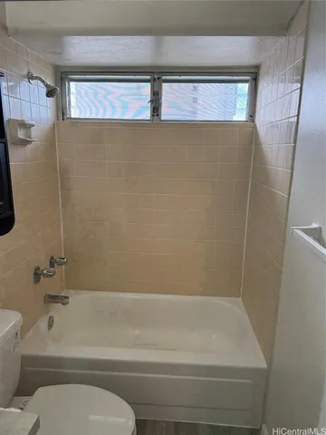 a bathroom with a shower and a toilet