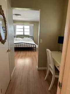 a view of a room with wooden floor and windows